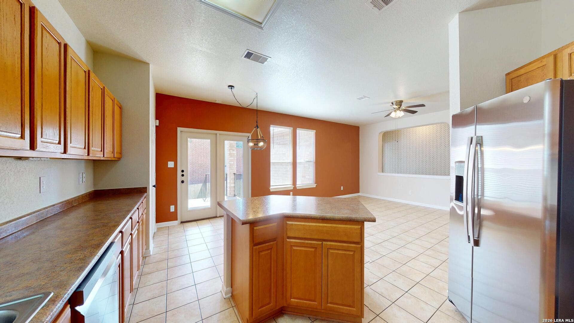 101 Springtree Cliff Cibolo, TX 78108 - Photo 19 of 46 a large kitchen with stainless steel appliances granite countertop a refrigerator and a sink