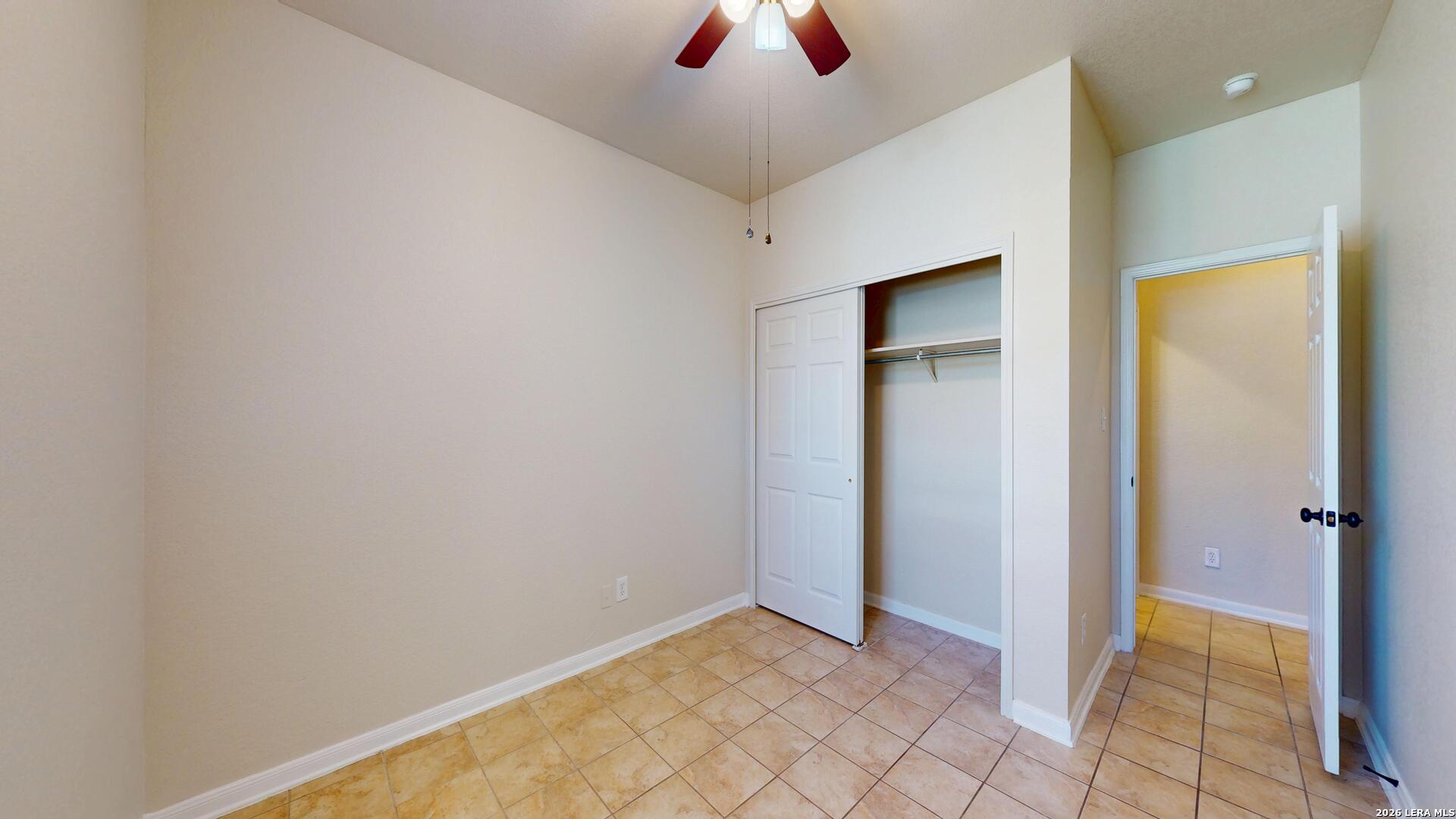 101 Springtree Cliff Cibolo, TX 78108 - Photo 32 of 46 an empty room with closet and a chandelier fan