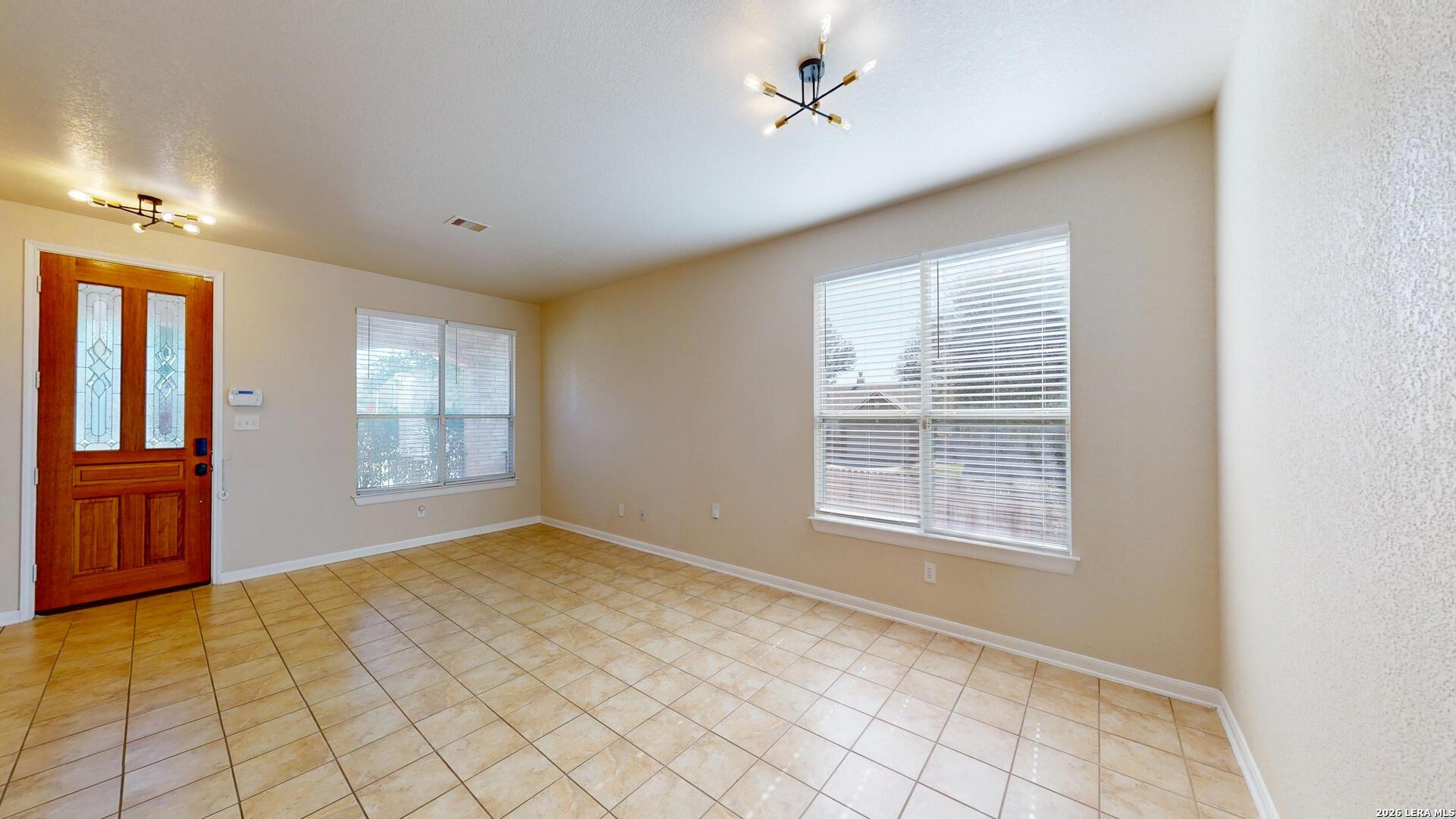 101 Springtree Cliff Cibolo, TX 78108 - Photo 8 of 46 a view of an empty room with a window
