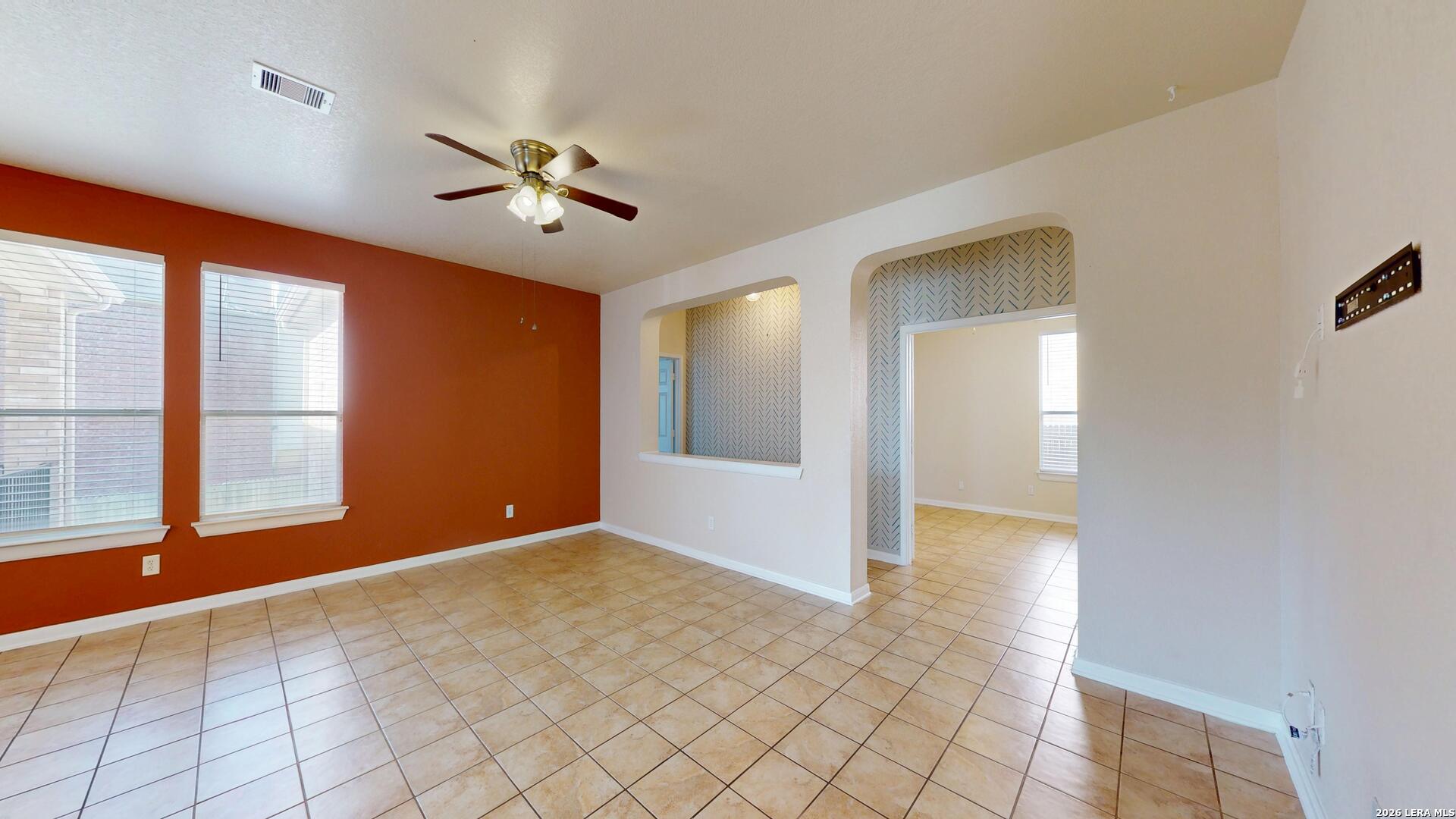 101 Springtree Cliff Cibolo, TX 78108 - Photo 10 of 46 a view of an empty room with window and chandelier fan