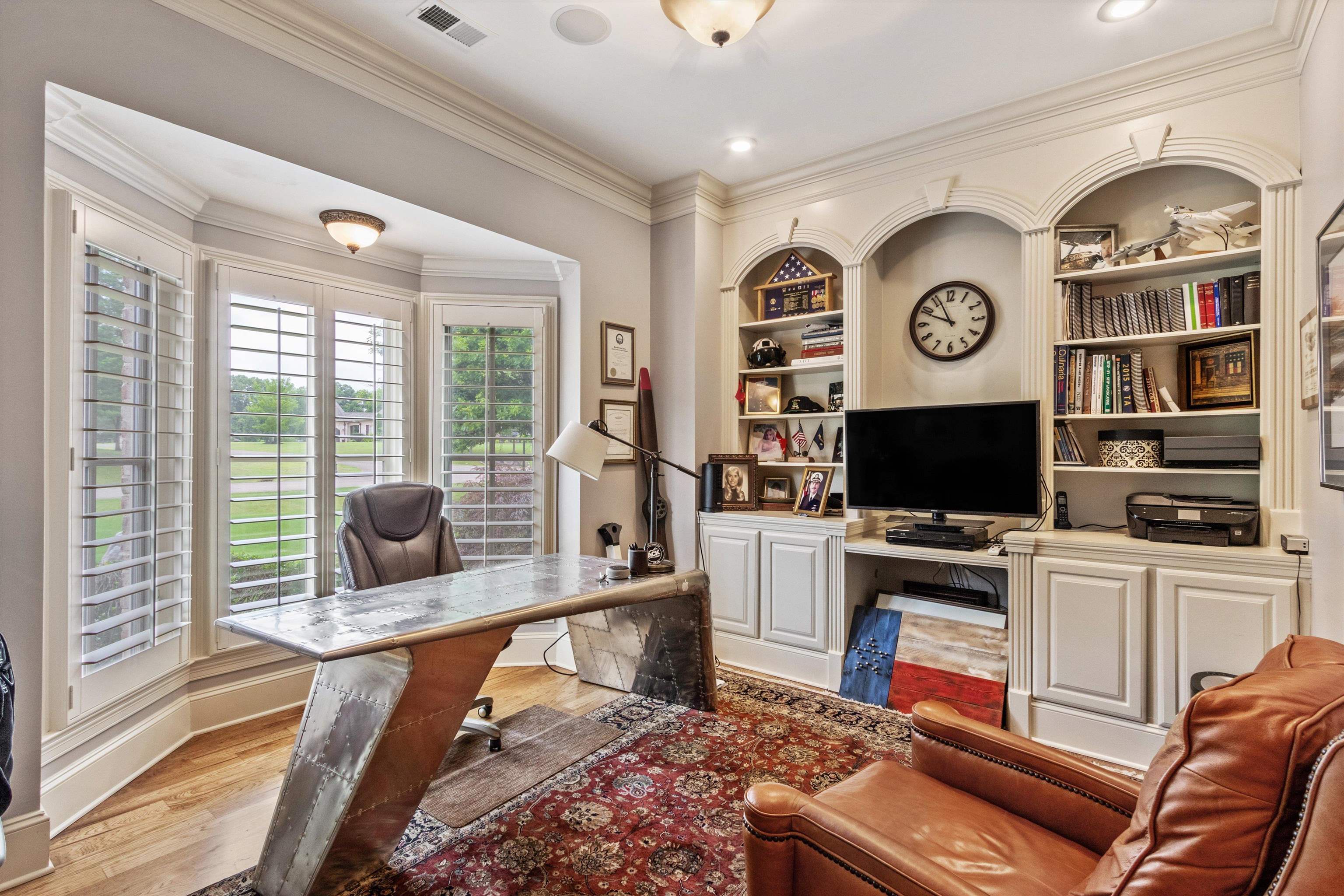 150 Ridgecrest Drive Arlington, TN 38002 - Photo 7 of 40 Dedicated room featuring a bay window with plantation shutters, extensive crown molding, recessed lighting, and built-in arched shelving with lower cabinetry