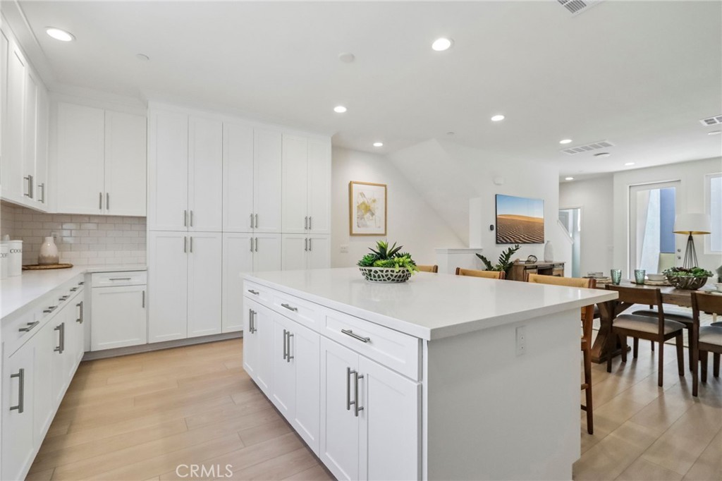 a kitchen with white cabinets appliances and white cabinets