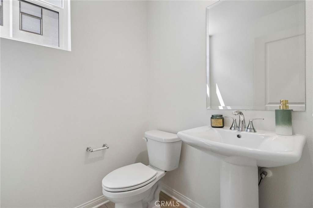 5868 Linden, Unit 6 Long Beach, CA 90805 - Photo 11 of 34 a bathroom with a sink a toilet and mirror