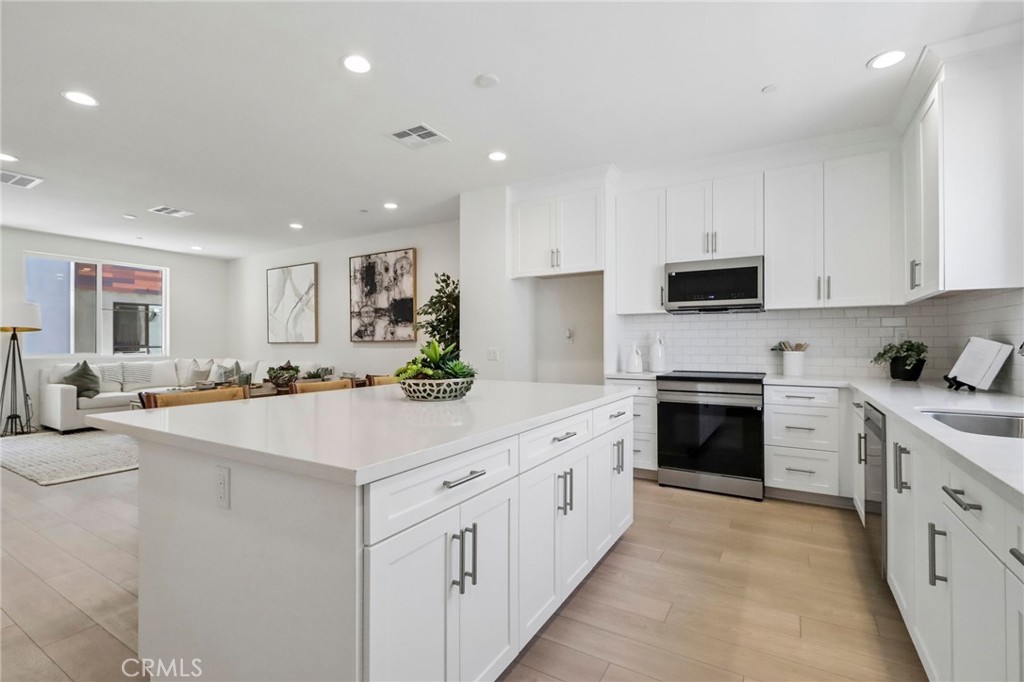 5868 Linden, Unit 6 Long Beach, CA 90805 - Photo 2 of 34 a kitchen with stainless steel appliances kitchen island granite countertop a sink and cabinets