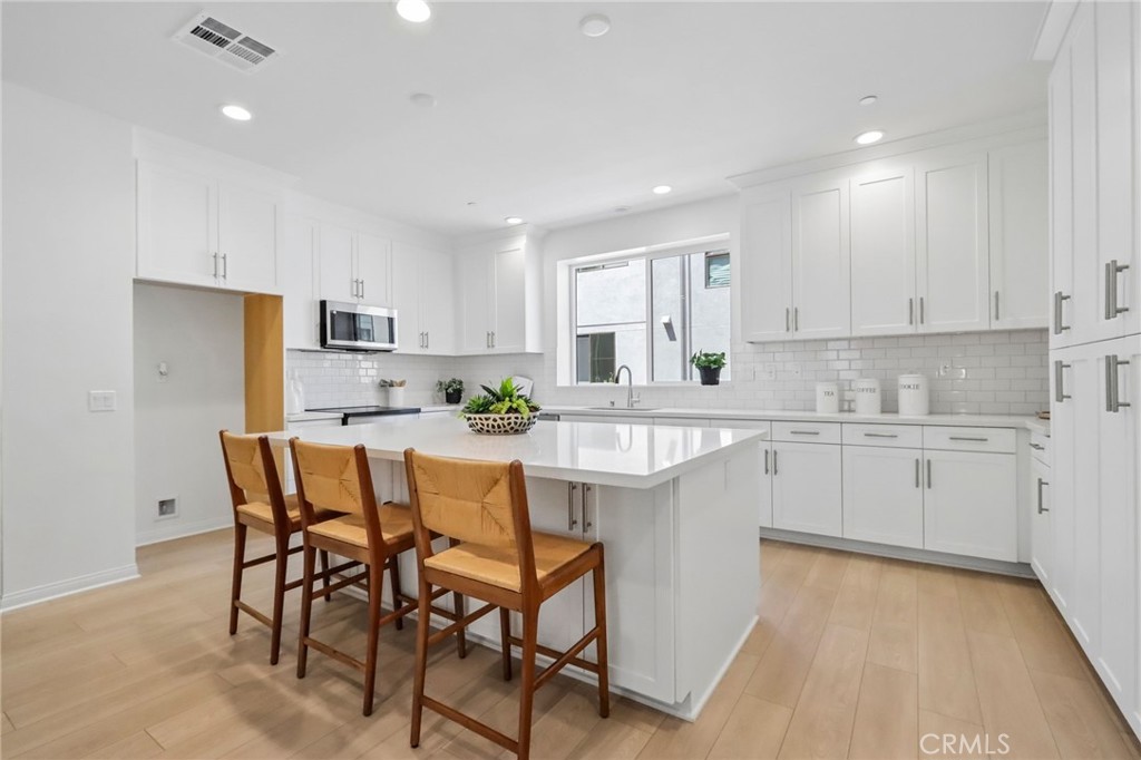 5868 Linden, Unit 6 Long Beach, CA 90805 - Photo 3 of 34 a kitchen with stainless steel appliances kitchen island granite countertop a sink and cabinets