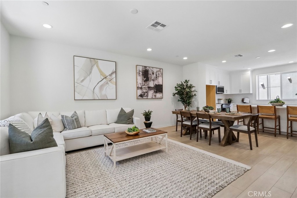 5868 Linden, Unit 6 Long Beach, CA 90805 - Photo 7 of 34 a living room with furniture potted plant and white walls