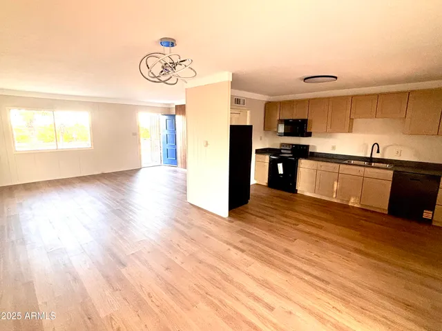 a kitchen with stainless steel appliances granite countertop a sink and cabinets