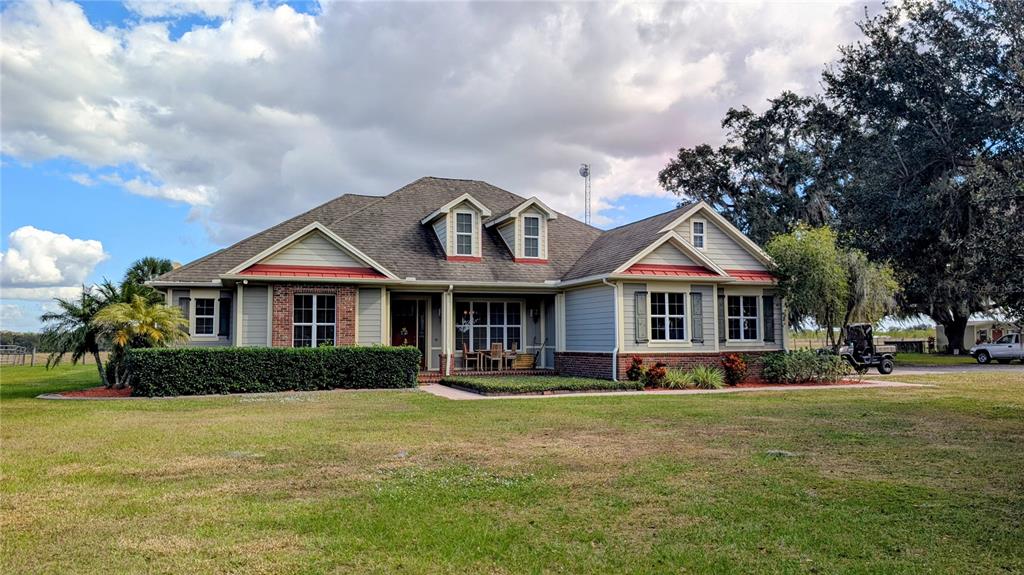 7053 George Marsh Road Zolfo Springs, FL 33890 - Photo 3 of 84 a front view of a house with a garden