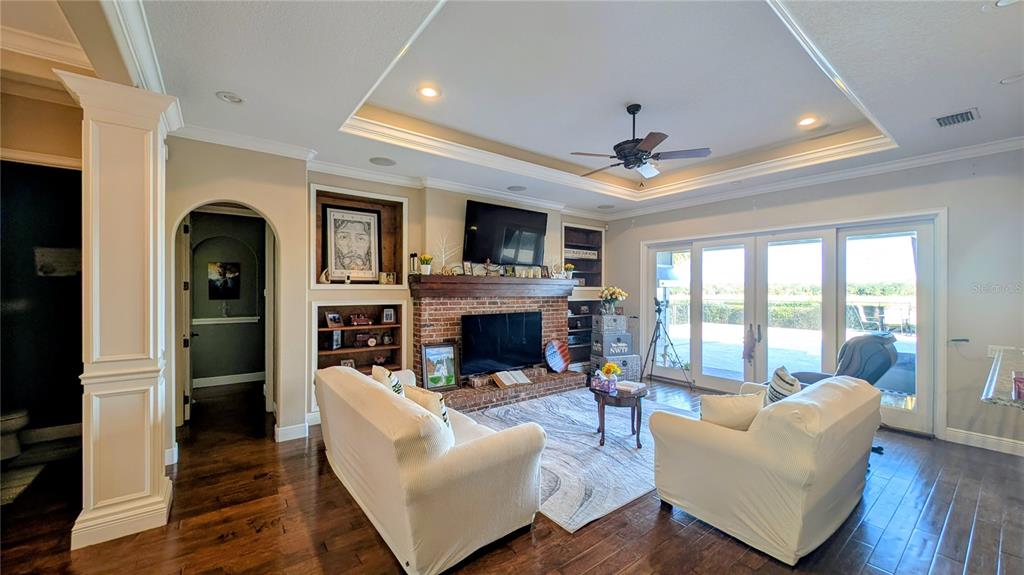 7053 George Marsh Road Zolfo Springs, FL 33890 - Photo 37 of 84 a living room with furniture a fireplace and a flat screen tv