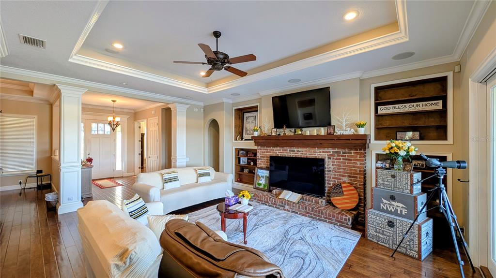 7053 George Marsh Road Zolfo Springs, FL 33890 - Photo 38 of 84 a living room with furniture a fireplace and a flat screen tv