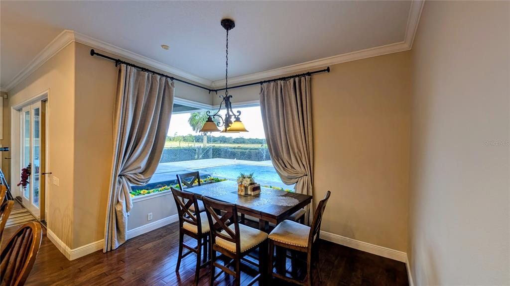 7053 George Marsh Road Zolfo Springs, FL 33890 - Photo 43 of 84 a view of a dining room with furniture window and wooden floor