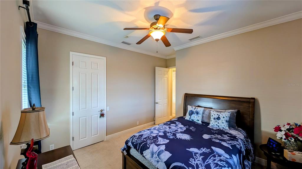 7053 George Marsh Road Zolfo Springs, FL 33890 - Photo 49 of 84 a bedroom with a bed and a chandelier