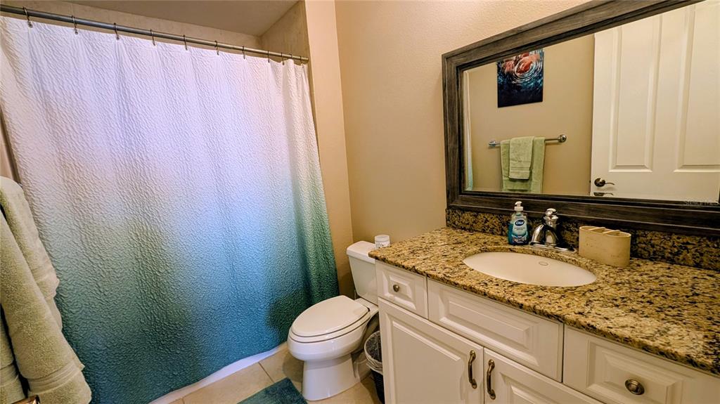 7053 George Marsh Road Zolfo Springs, FL 33890 - Photo 50 of 84 a bathroom with a granite countertop sink and a mirror
