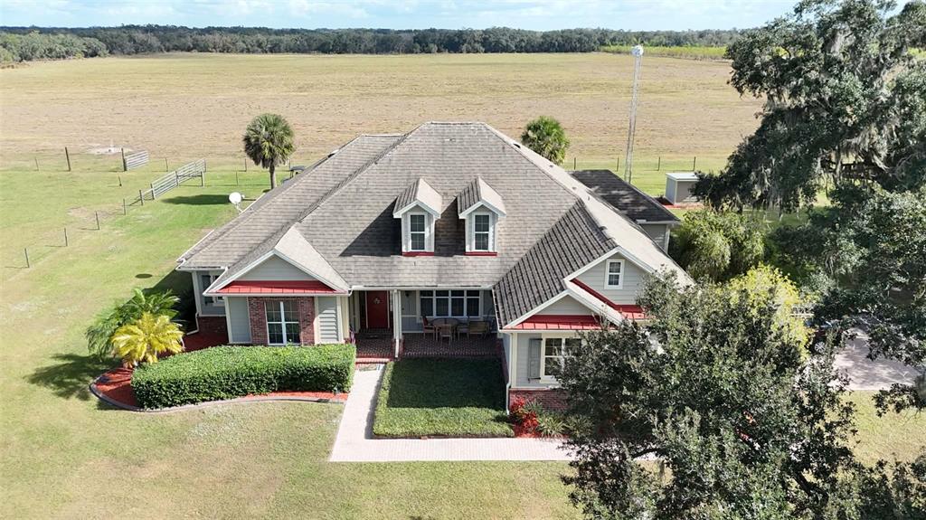7053 George Marsh Road Zolfo Springs, FL 33890 - Photo 62 of 84 a aerial view of a house next to a lake with a lake view