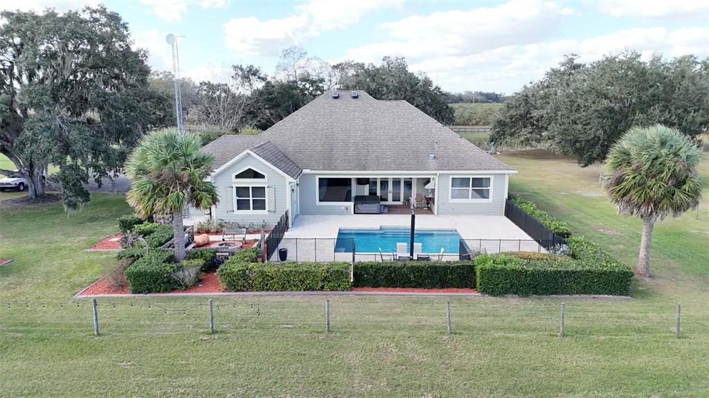 7053 George Marsh Road Zolfo Springs, FL 33890 - Photo 76 of 84 a front view of a house with a yard and potted plants