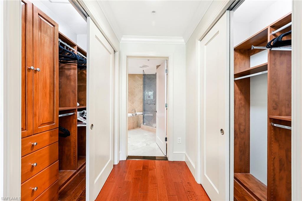 9115 Strada Place, Unit 5201 Naples, FL 34108 - Photo 11 of 22 a view of hallway with stairs and wooden floor
