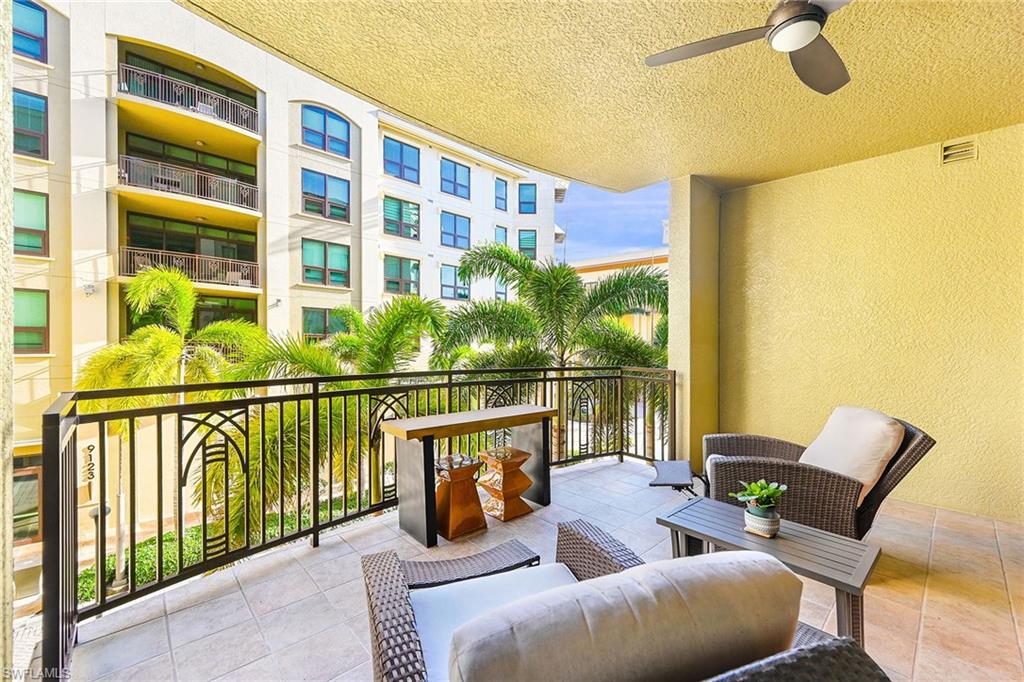 9115 Strada Place, Unit 5201 Naples, FL 34108 - Photo 21 of 22 a balcony with furniture and a large window