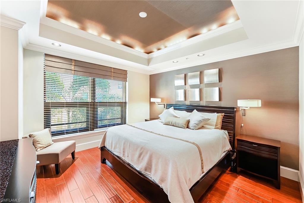 9115 Strada Place, Unit 5201 Naples, FL 34108 - Photo 9 of 22 a bedroom with a bed and a large window