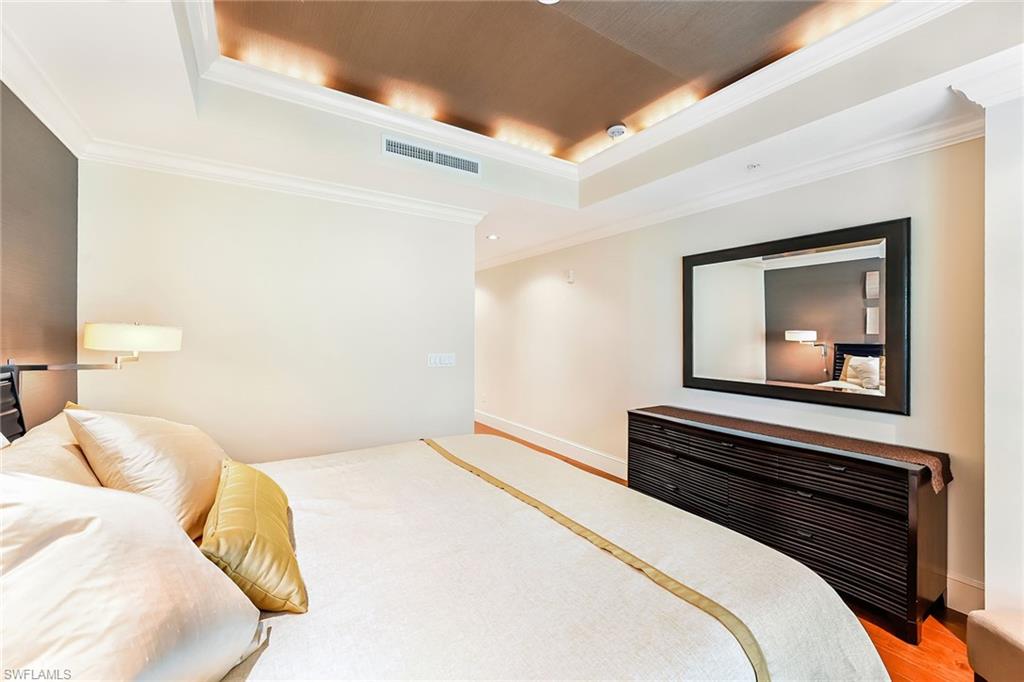 9115 Strada Place, Unit 5201 Naples, FL 34108 - Photo 10 of 22 a bedroom with a bed and a painting on the wall