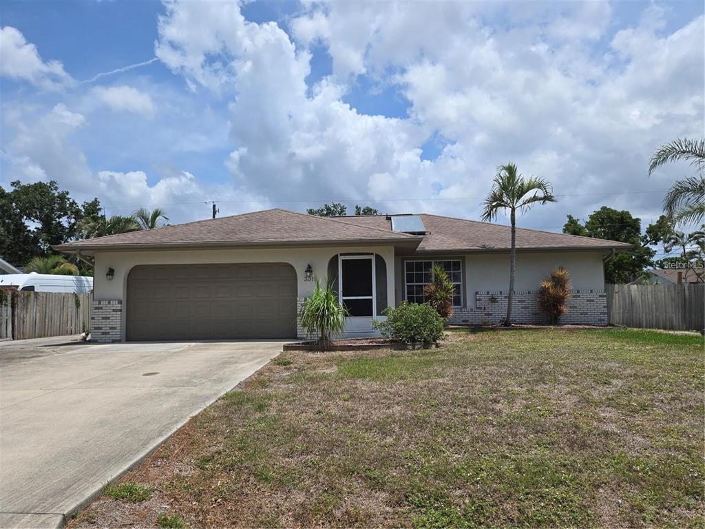 a front view of a house with yard and garage