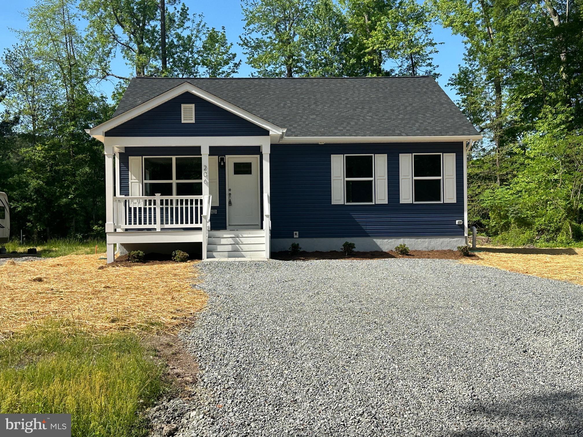 245 Azure Drive Colonial Beach, VA 22443 - Photo 2 of 4 a front view of a house with a yard