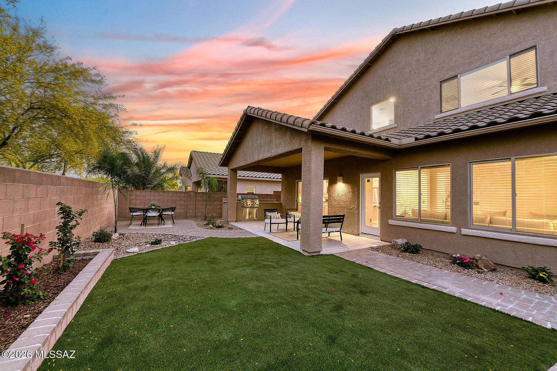 13464 North Piemonte Way Oro Valley, AZ 85755 - Photo 4 of 33 a front view of a house with a garden and patio