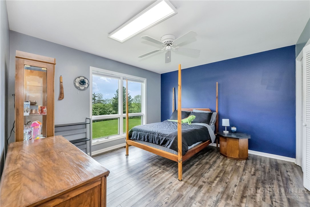 939 Don Bare Road Jefferson, NC 28640 - Photo 16 of 49 a bedroom with a bed and wooden floor