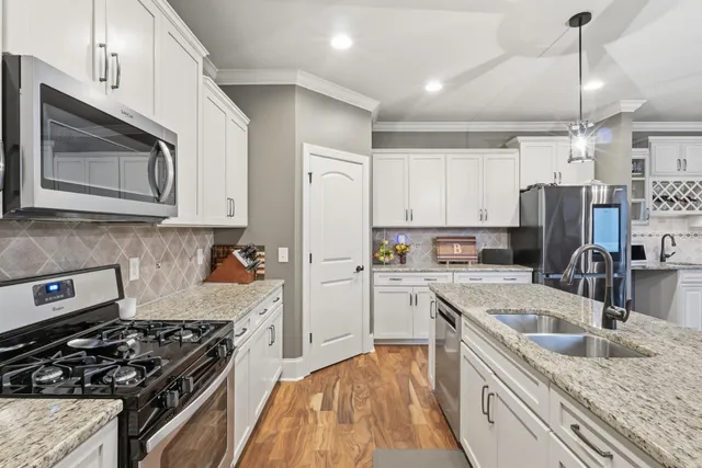 a kitchen with a stove sink and refrigerator
