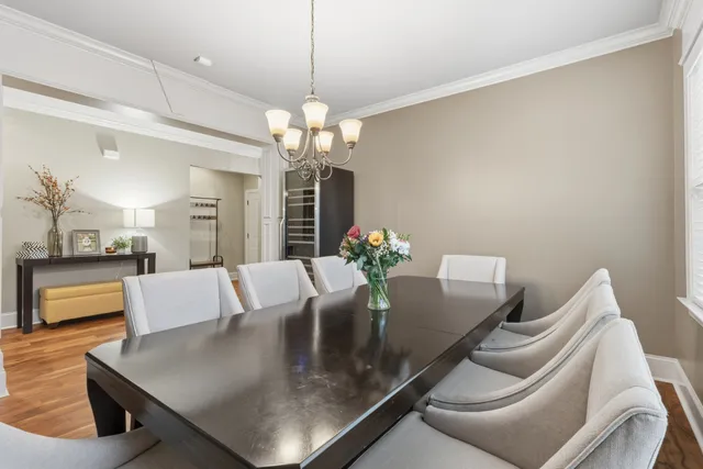 a view of a dining room with furniture and a chandelier