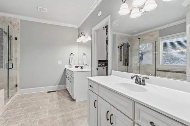 a spacious bathroom with a sink double vanity granite and a mirror
