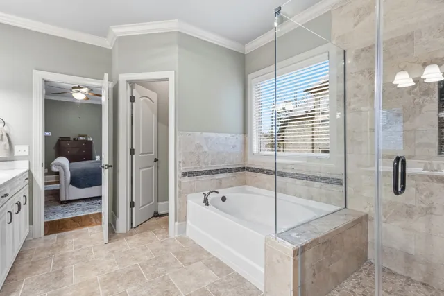 a bathroom with a tub and shower