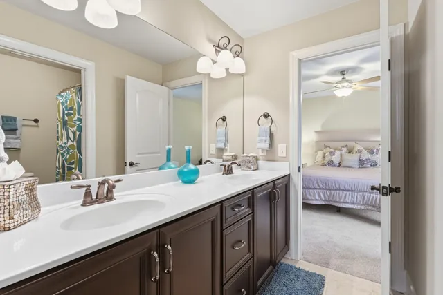 a en suite bathroom with a double vanity sink and a mirror