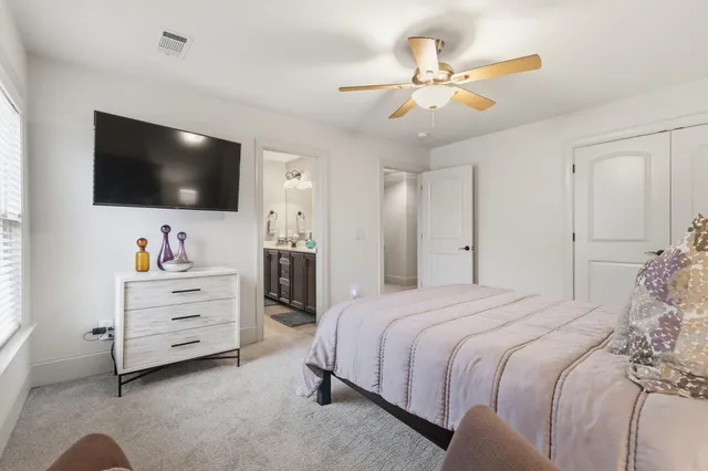 a bedroom with a bed and a flat screen tv