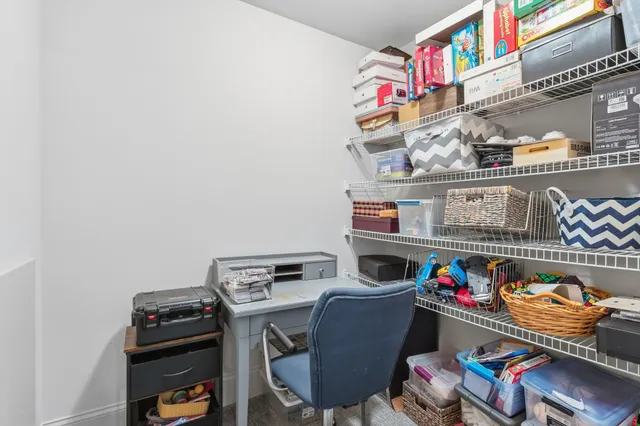 a living room with furniture and kitchen view