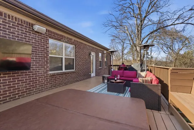 a view of a roof deck with wooden floor and outdoor seating