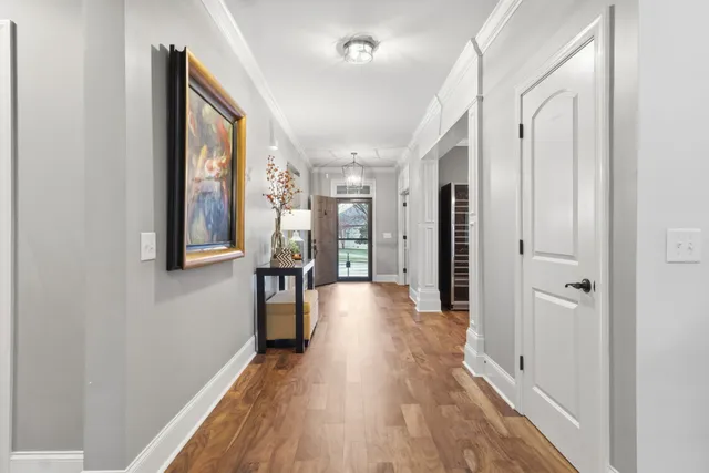 a view of a hallway with wooden floor
