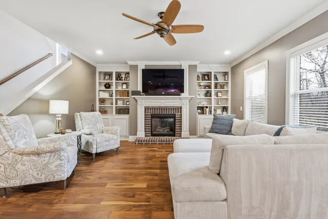 a living room with furniture a flat screen tv and a fireplace