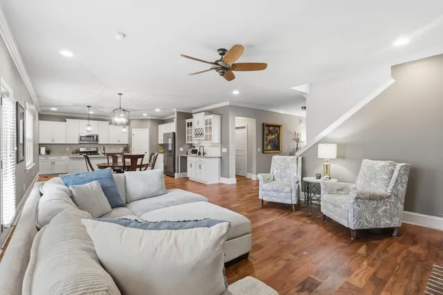 a living room with furniture and kitchen view