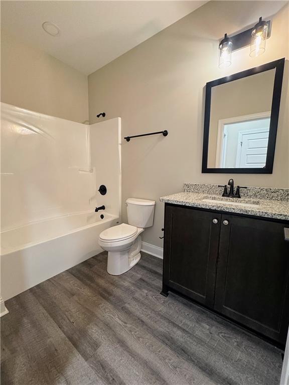 7217 King Road Valley, AL 36854 - Photo 11 of 14 Bathroom featuring vanity, bathing tub / shower combination, and dark wood-style flooring
