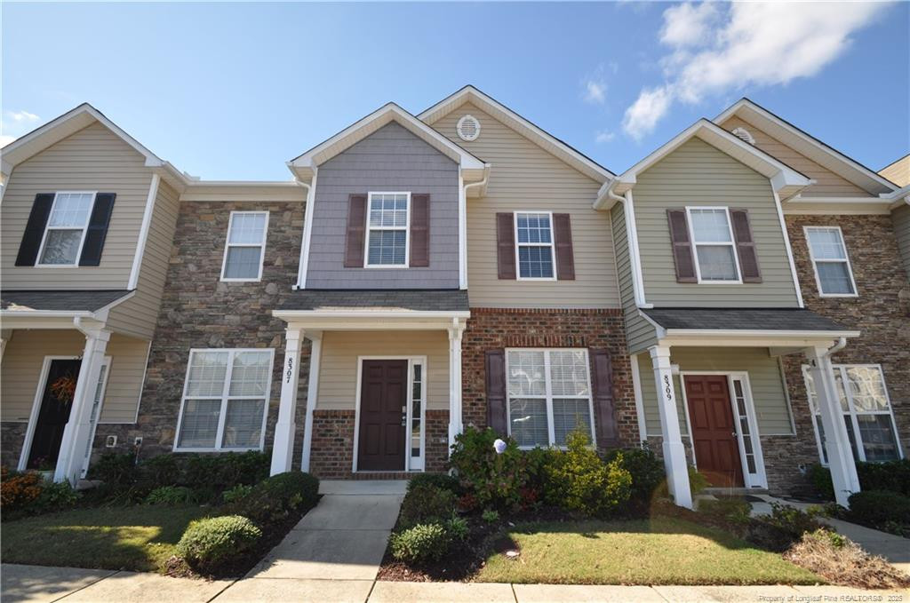 a front view of a house with a yard