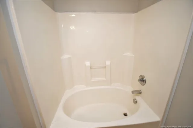 a white bath tub sitting in a bathroom