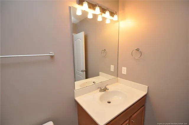 a bathroom with a sink a mirror and vanity
