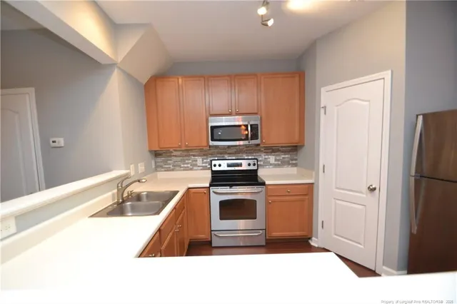 a kitchen with a refrigerator sink and stove