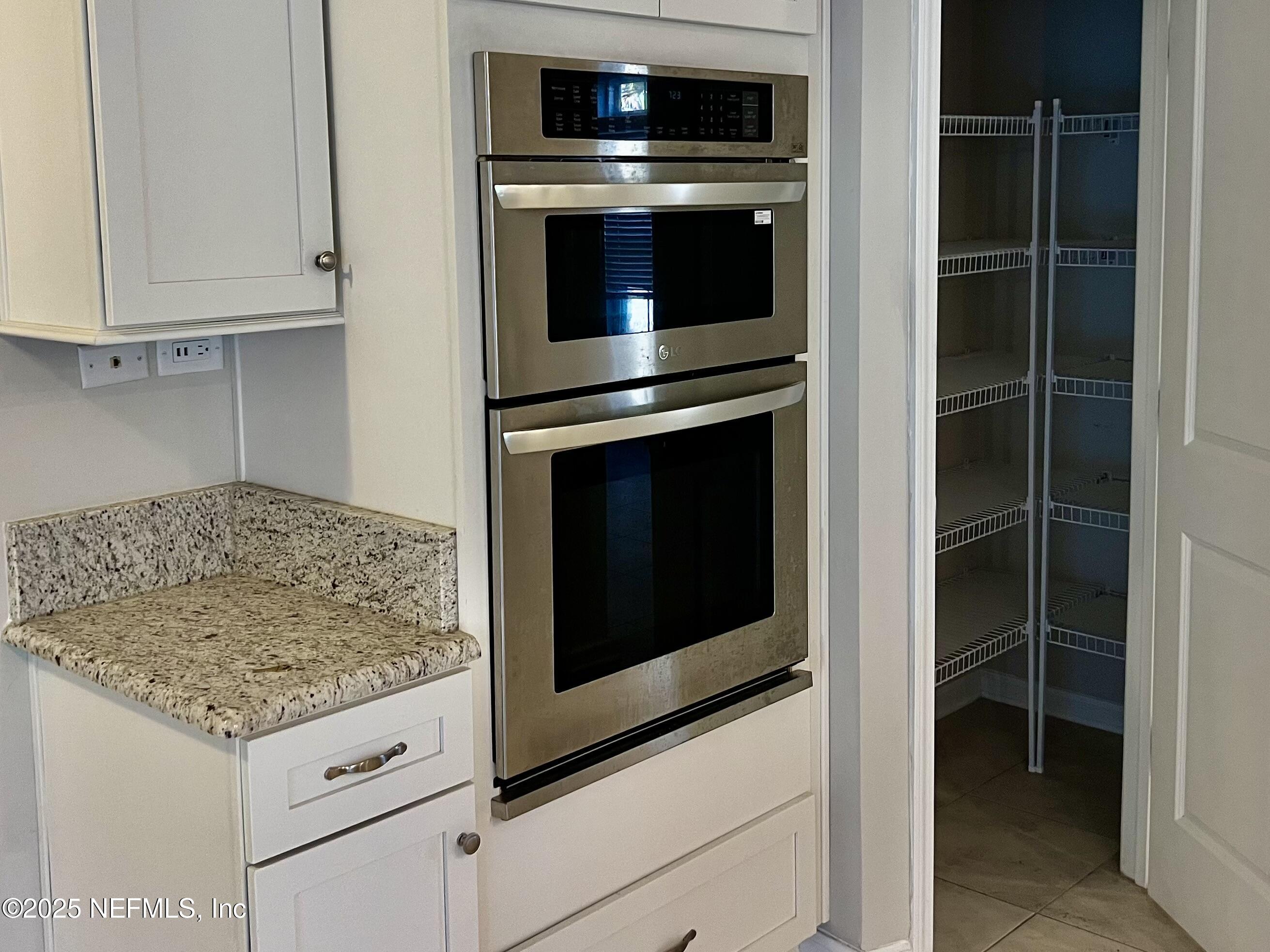 85806 Black Tern Drive Yulee, FL 32097 - Photo 11 of 38 a kitchen with granite countertop cabinets and steel stainless steel appliances