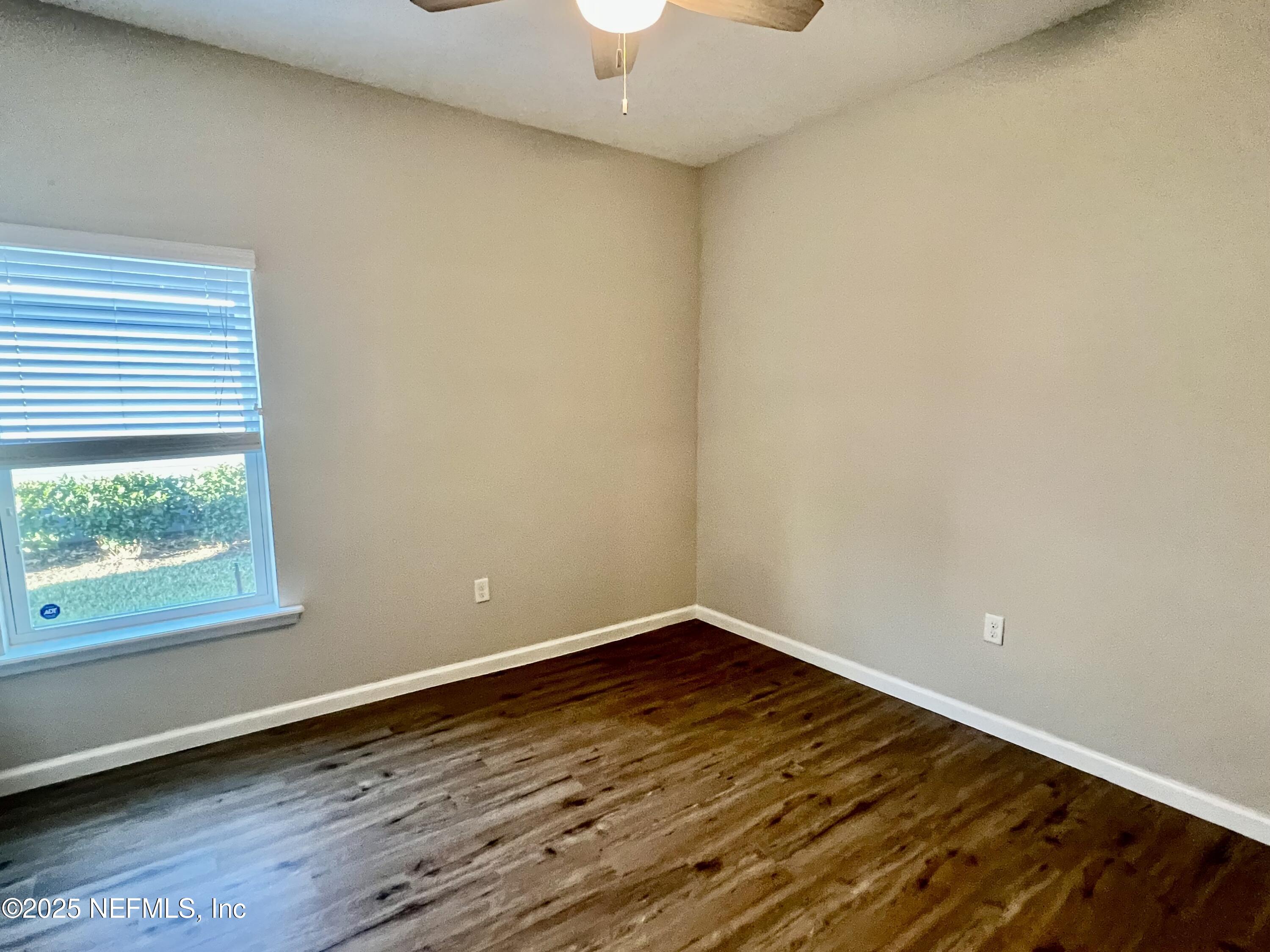 85806 Black Tern Drive Yulee, FL 32097 - Photo 16 of 38 a view of an empty room with wooden floor and a window