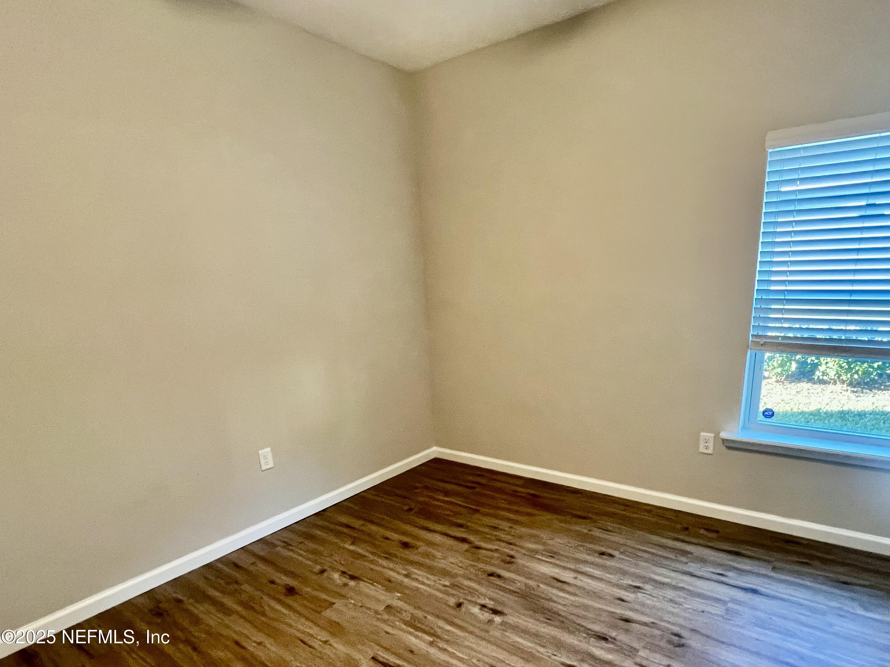 85806 Black Tern Drive Yulee, FL 32097 - Photo 17 of 38 a view of an empty room with wooden floor and a window