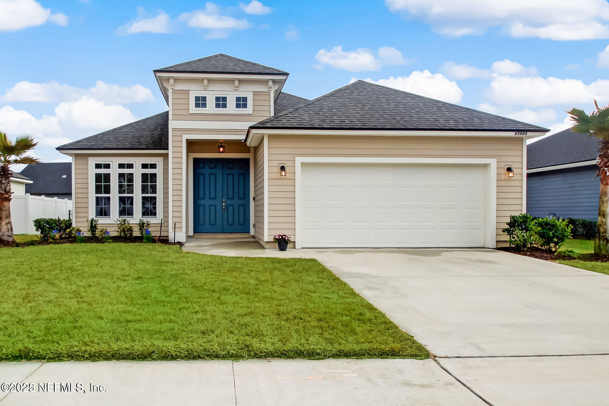 85806 Black Tern Drive Yulee, FL 32097 - Photo 2 of 38 a front view of a house with a garden