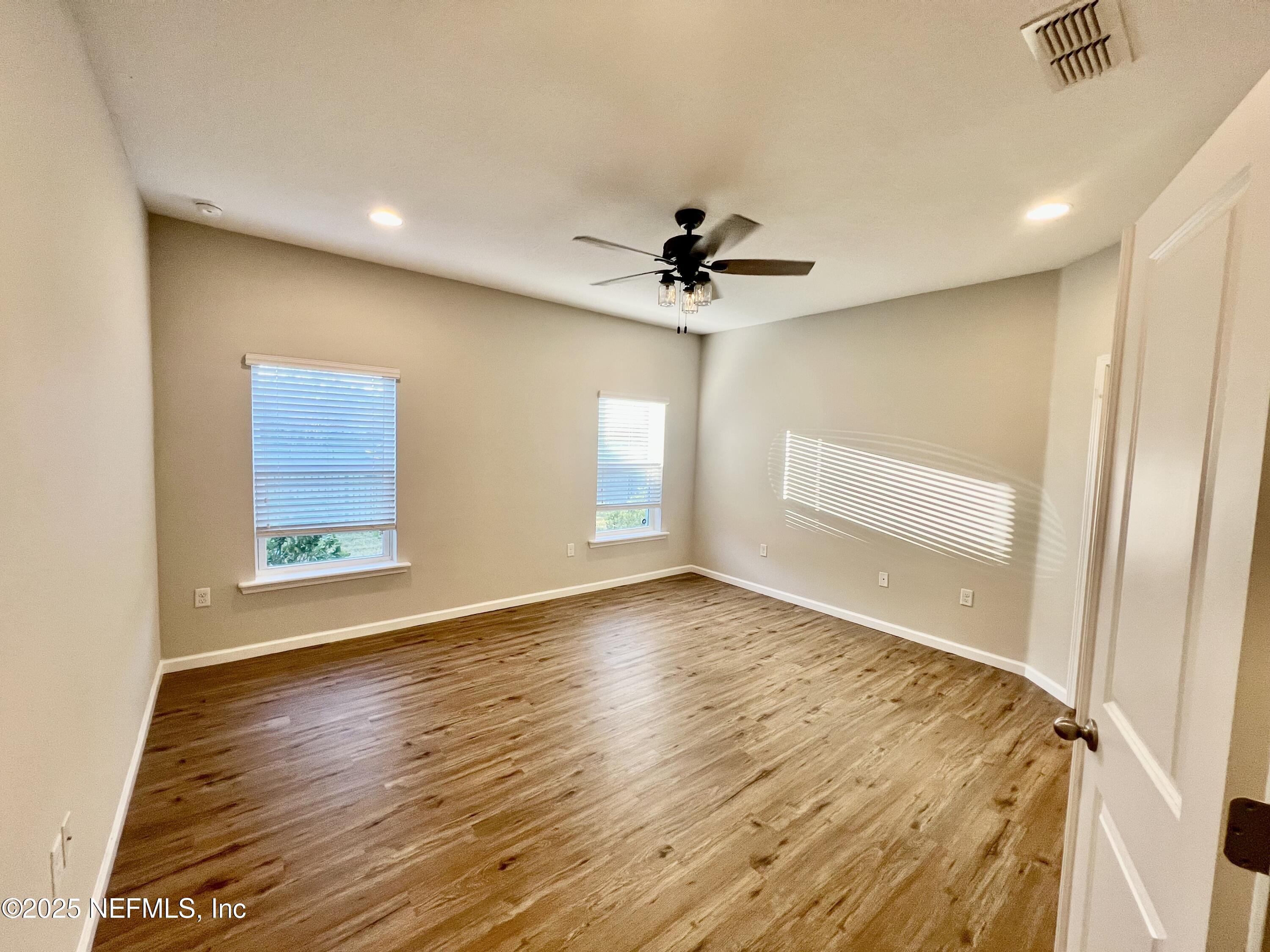 85806 Black Tern Drive Yulee, FL 32097 - Photo 23 of 38 a view of empty room with wooden floor and fan