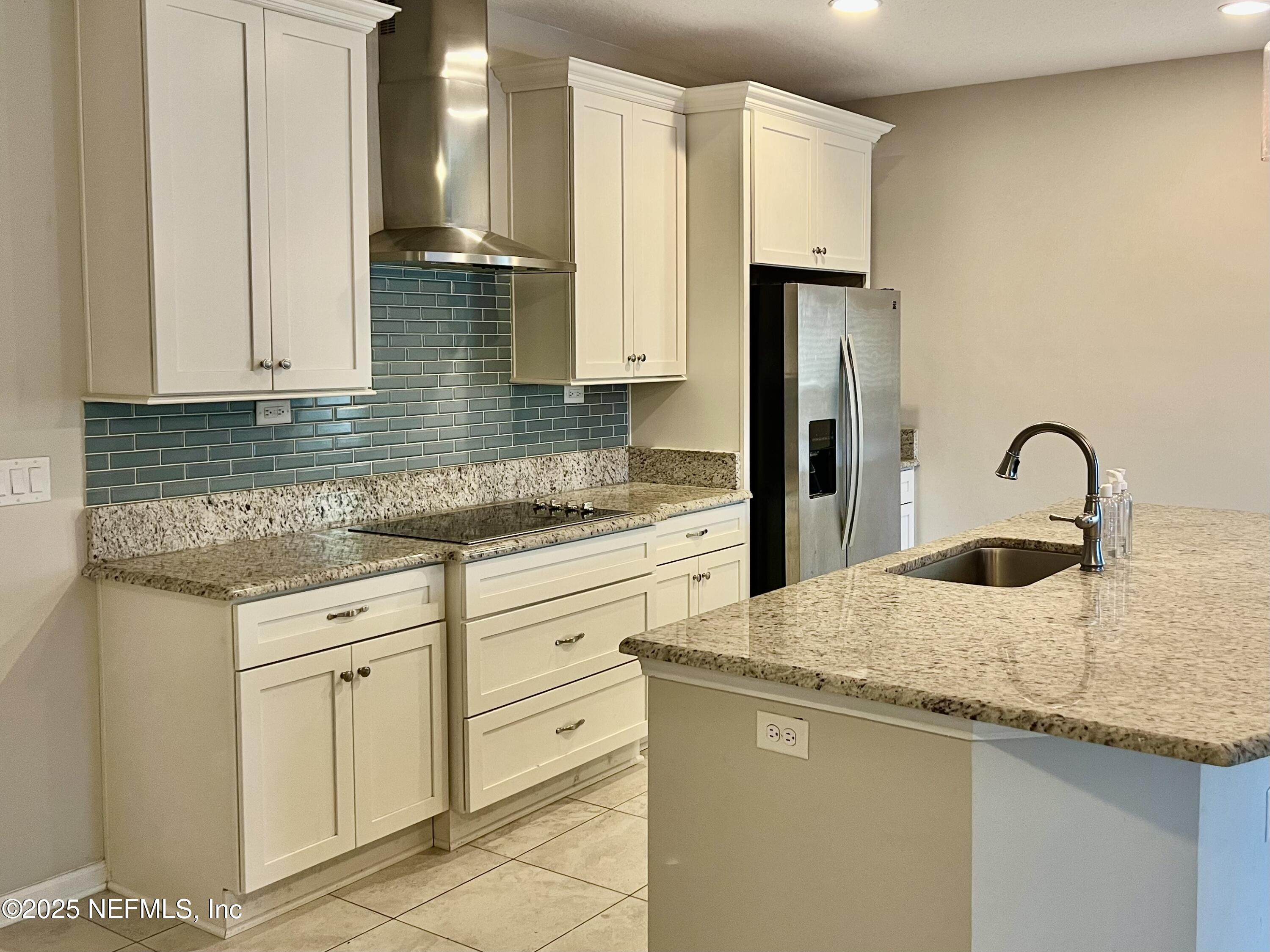 85806 Black Tern Drive Yulee, FL 32097 - Photo 7 of 38 a kitchen with granite countertop a sink stainless steel appliances and cabinets