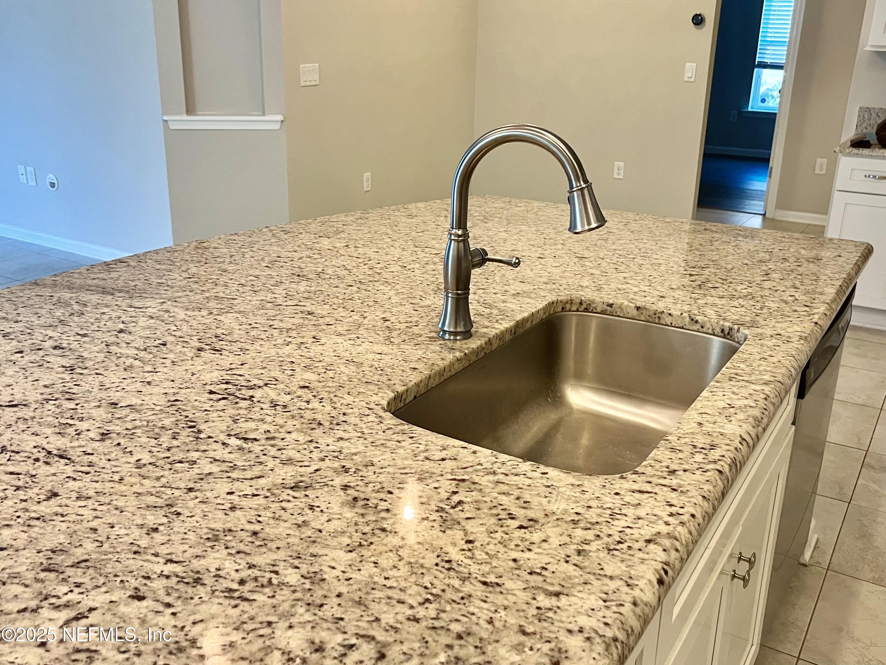 85806 Black Tern Drive Yulee, FL 32097 - Photo 10 of 38 a view of a kitchen island with a sink and wooden floor